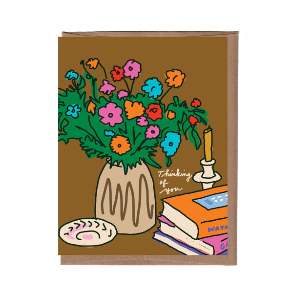Card with colorful floral illustration on a brown background
